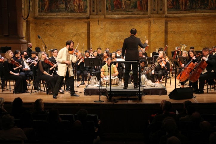 Conductor, Violin soloist, and full orchestra with tabla and sitar.