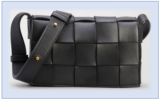 A shoulder bag by Bottega Veneta. The bag is black and appears to have a grid-like pattern. There are gold studs on the shoulder strap.