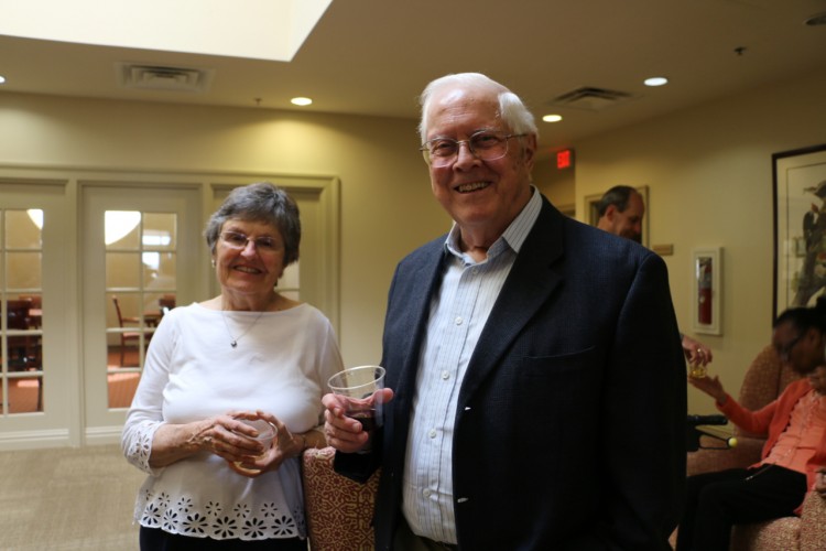 Older lady and gentleman standing in the lobby