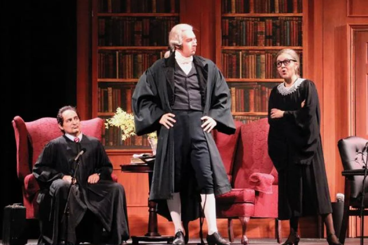 Justices Antonin Scalia (Nicholas Nestorak) and Ruth Bader Ginsburg (Kelly Guerra) defend themselves before The Commentator (Cody Muller). 