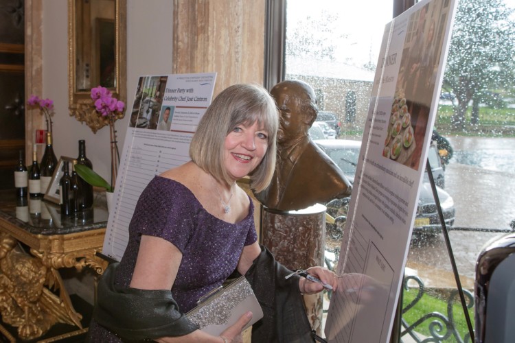 Gala attendee signing up for a party board offering