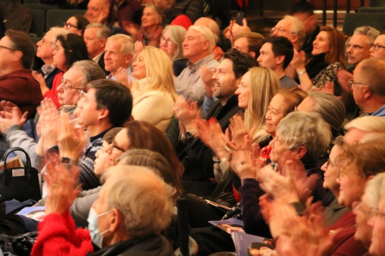 Audience members clapping