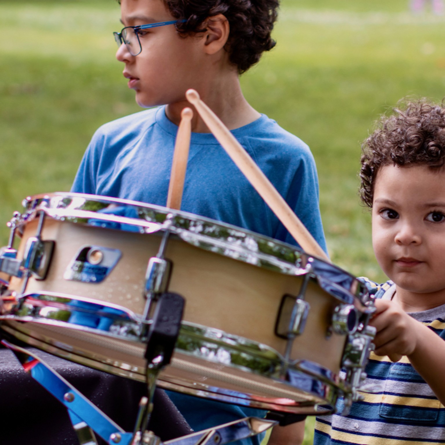 Child playing a snare drum
