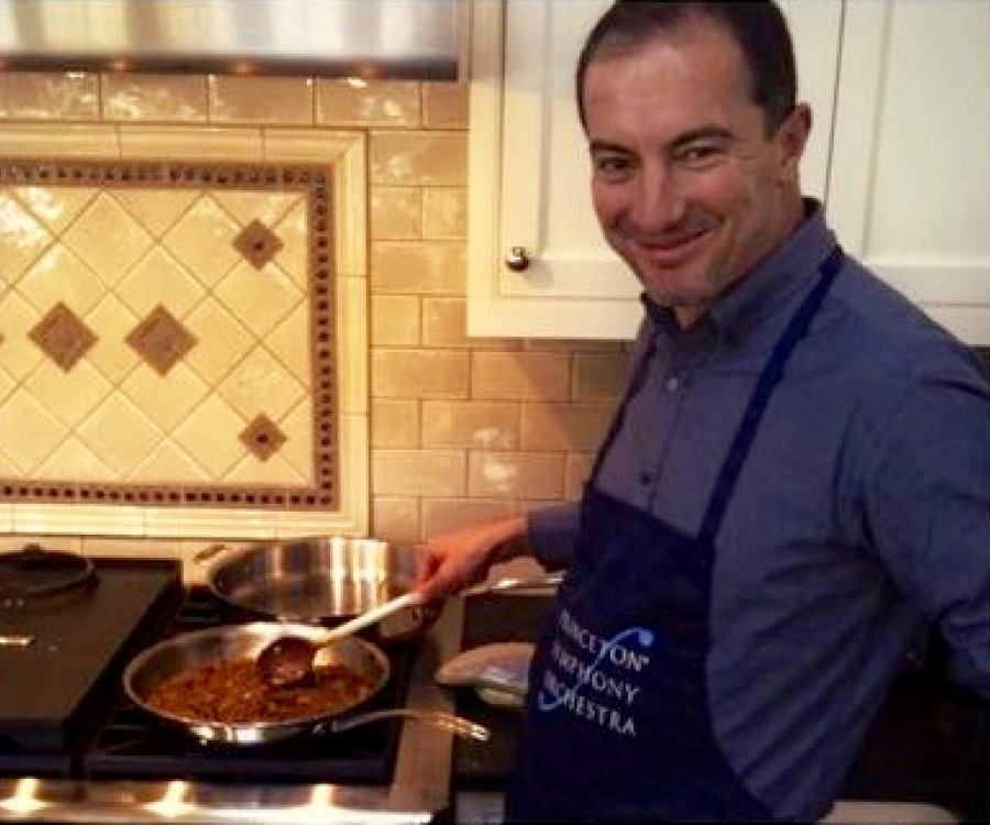 Rossen Milanov at the stove, wearing a PSO apron.