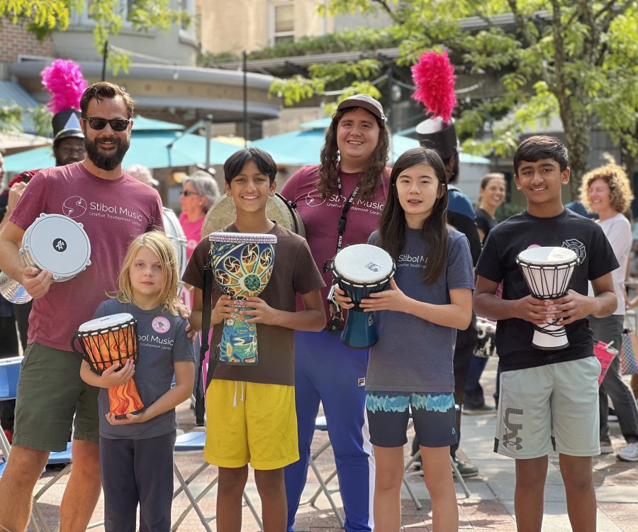 Drum circle participants holding hand percussion instruments