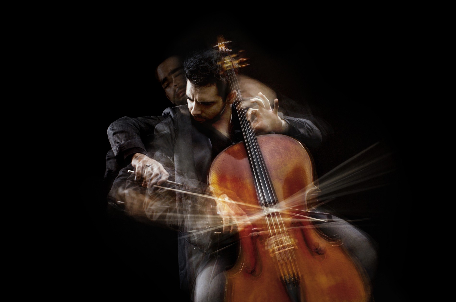 Pablo Ferrández playing the cello against black background