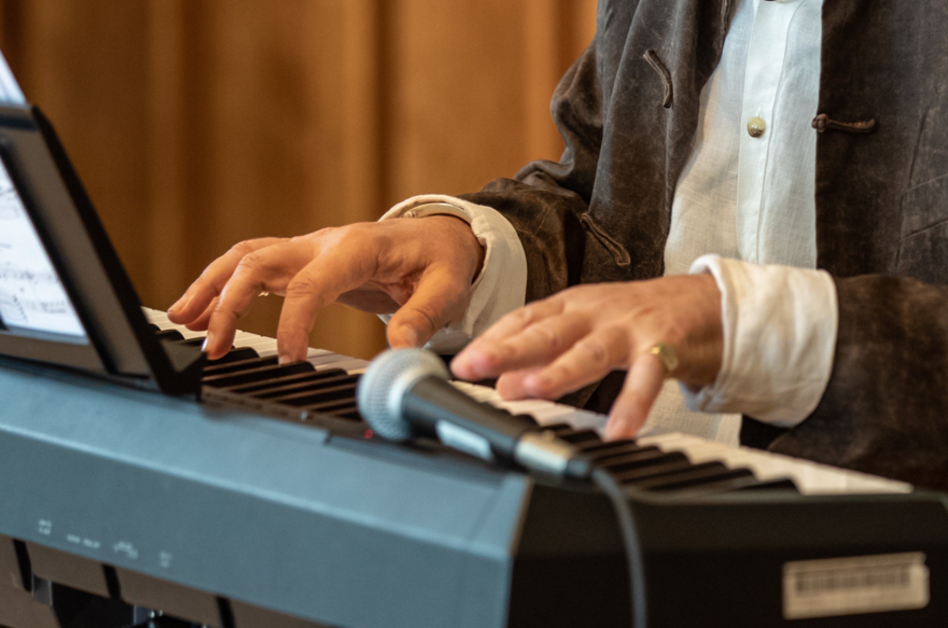 Composer fingers on keyboard